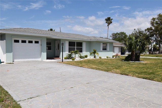 123 9th St, Belleair Beach, FL 33786 - single story home with stucco siding, driveway, a front yard, and a garage