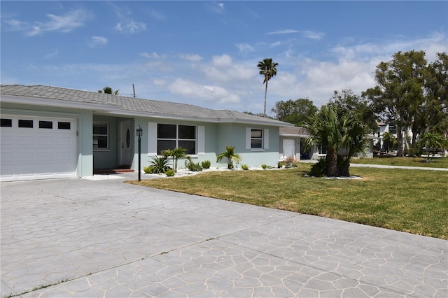 123 9th St, Belleair Beach, FL 33786 - ranch-style home with a tile roof, concrete driveway, an attached garage, a front yard, and stucco siding