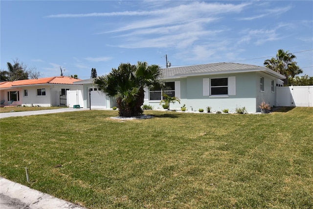 123 9th St, Belleair Beach, FL 33786 - ranch-style house with a garage, a front lawn, stucco siding, and fence