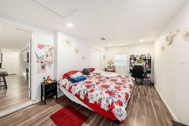 bedroom featuring dark hardwood / wood-style flooring and a closet