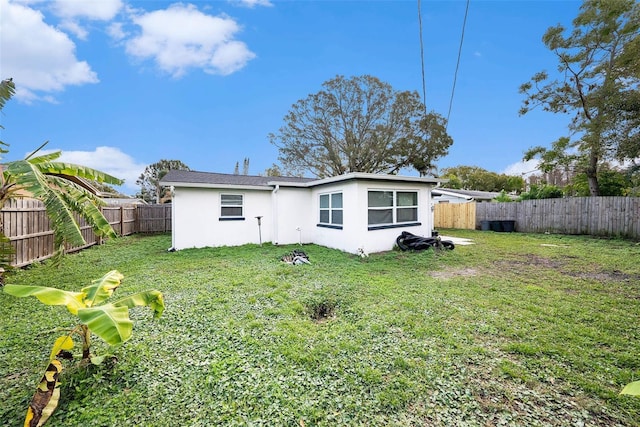 rear view of house featuring a lawn