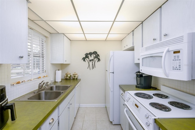 kitchen with sink, backsplash, white appliances, a paneled ceiling, and white cabinets