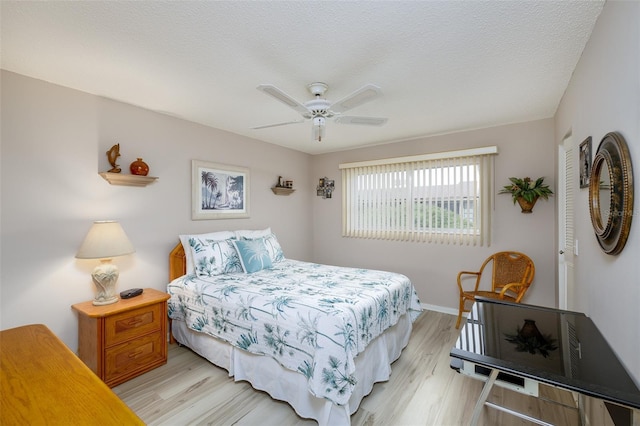 bedroom with ceiling fan, a closet, a textured ceiling, and light wood-type flooring