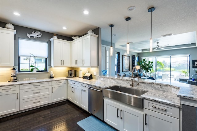 kitchen with sink, stainless steel dishwasher, decorative light fixtures, decorative backsplash, and white cabinets