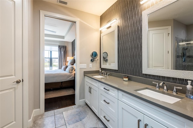 bathroom featuring vanity and a shower with door