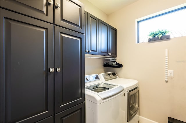 laundry room featuring cabinets and washing machine and clothes dryer