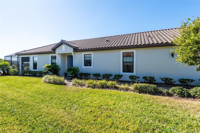 mediterranean / spanish-style home featuring a front yard