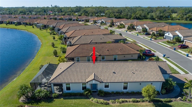 birds eye view of property with a water view