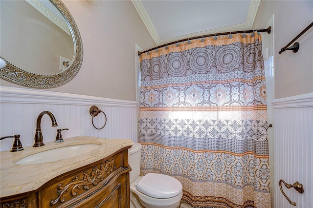 bathroom featuring vanity, toilet, and crown molding