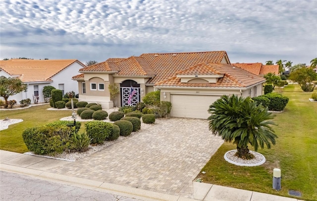 mediterranean / spanish home with a front yard