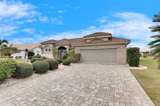 mediterranean / spanish home featuring a garage