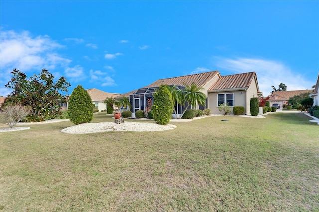 exterior space with a front lawn and glass enclosure