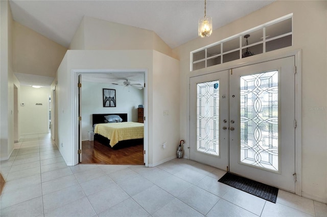 tiled entryway featuring ceiling fan and french doors