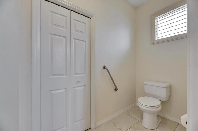 bathroom with toilet and tile patterned flooring