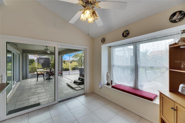 unfurnished sunroom with ceiling fan and vaulted ceiling