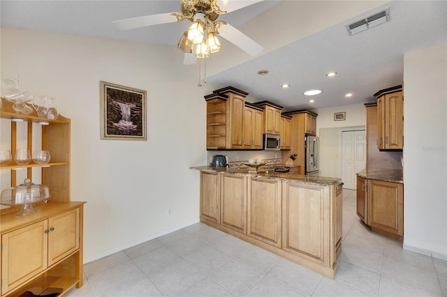 kitchen with ceiling fan, stone countertops, stainless steel appliances, and light tile patterned flooring