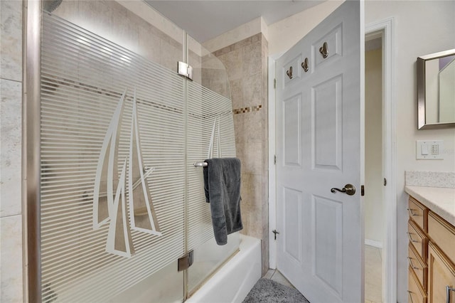 bathroom with tile patterned floors, enclosed tub / shower combo, and vanity