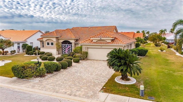 mediterranean / spanish house featuring a front lawn