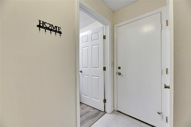 doorway to outside featuring light tile patterned floors