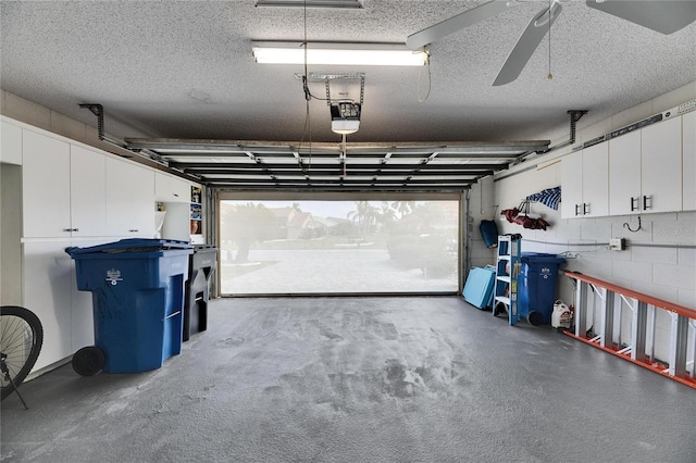 garage with ceiling fan and a garage door opener