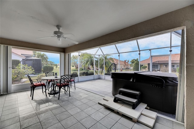 sunroom with ceiling fan and a hot tub