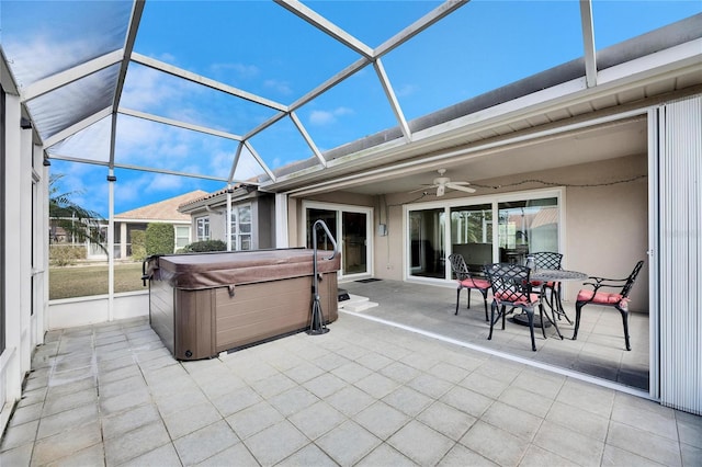 view of patio with ceiling fan, a hot tub, and a lanai