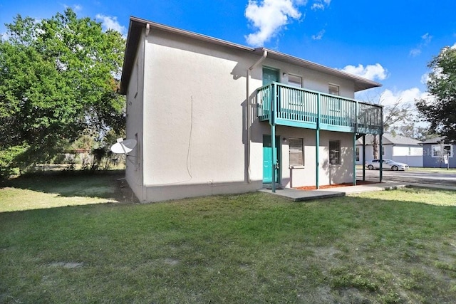 rear view of house with a yard