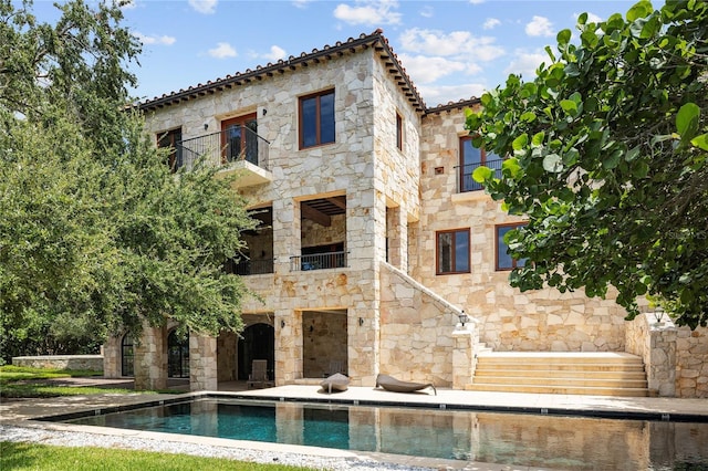 back of house with a balcony