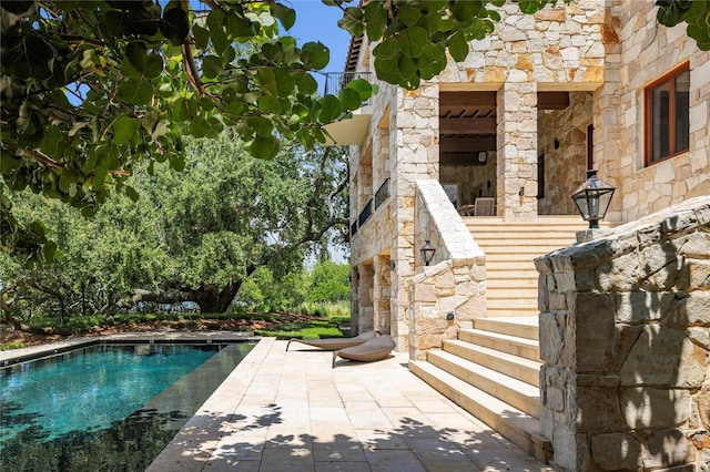 view of swimming pool featuring a patio area