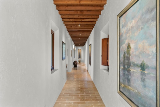 hallway featuring beamed ceiling and wooden ceiling