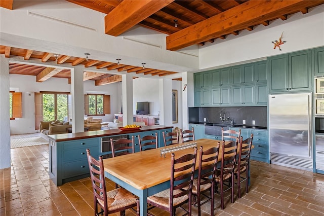 dining space with beamed ceiling and wooden ceiling