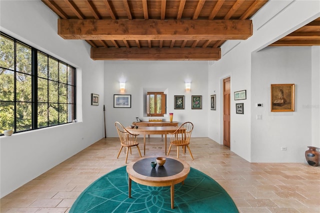 dining area featuring beamed ceiling and wooden ceiling