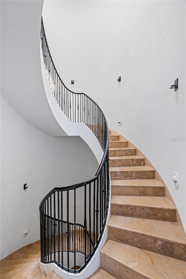 stairs featuring a towering ceiling