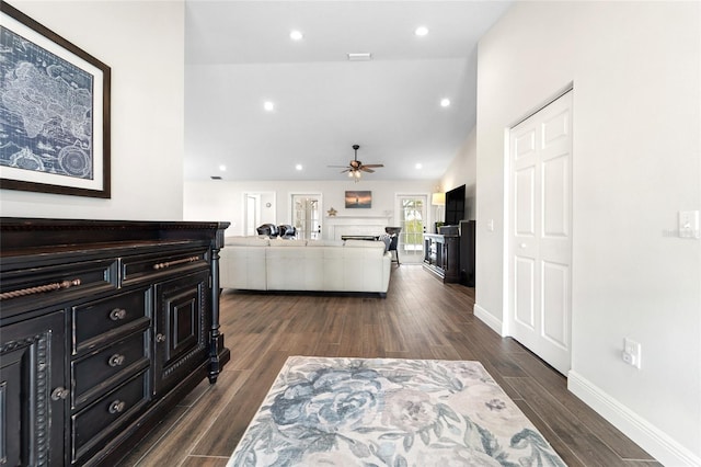 living room featuring vaulted ceiling, ceiling fan, and dark hardwood / wood-style flooring