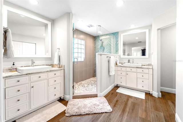 bathroom featuring vanity, an enclosed shower, and hardwood / wood-style floors