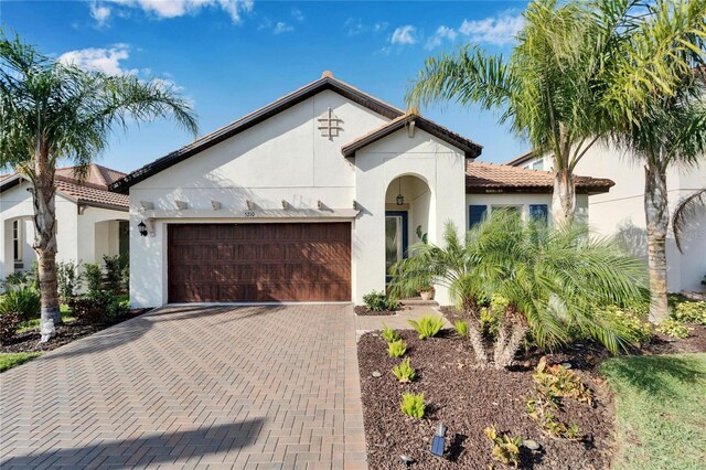 mediterranean / spanish-style home with a garage