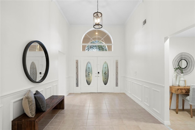 8701 Ballantrae Way, Tampa, FL 33647 - tiled foyer entrance featuring crown molding and a chandelier