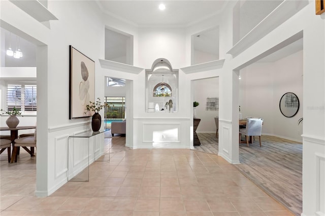 8701 Ballantrae Way, Tampa, FL 33647 - foyer featuring crown molding, plenty of natural light, and light tile patterned flooring