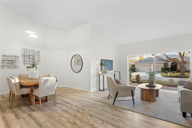 8701 Ballantrae Way, Tampa, FL 33647 - dining room featuring high vaulted ceiling, a chandelier, and light wood-type flooring