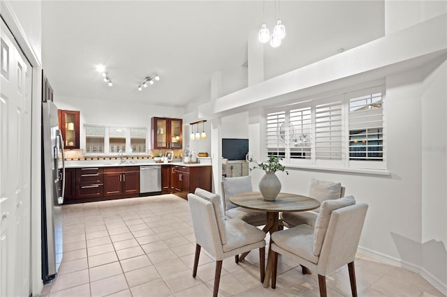 8701 Ballantrae Way, Tampa, FL 33647 - tiled dining area with sink, high vaulted ceiling, rail lighting, and a chandelier