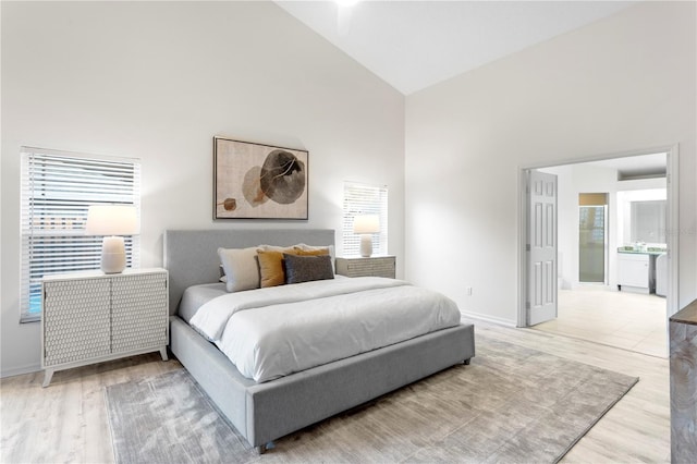 8701 Ballantrae Way, Tampa, FL 33647 - bedroom with high vaulted ceiling and light hardwood / wood-style flooring