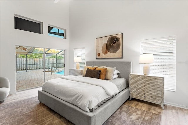 8701 Ballantrae Way, Tampa, FL 33647 - bedroom featuring hardwood / wood-style flooring, a towering ceiling, and access to outside