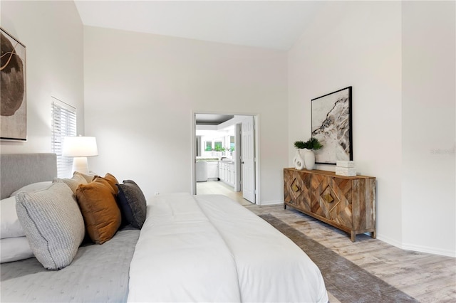 8701 Ballantrae Way, Tampa, FL 33647 - bedroom with connected bathroom, a towering ceiling, and hardwood / wood-style floors