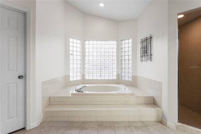 8701 Ballantrae Way, Tampa, FL 33647 - bathroom featuring plus walk in shower and tile patterned floors