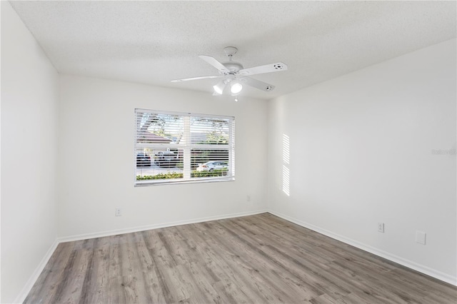 8701 Ballantrae Way, Tampa, FL 33647 - unfurnished room with ceiling fan, wood-type flooring, and a textured ceiling