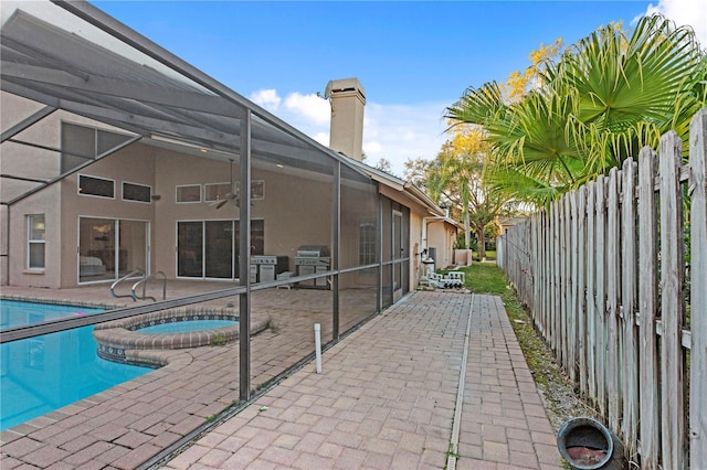 8701 Ballantrae Way, Tampa, FL 33647 - view of pool featuring an in ground hot tub, area for grilling, glass enclosure, and a patio area