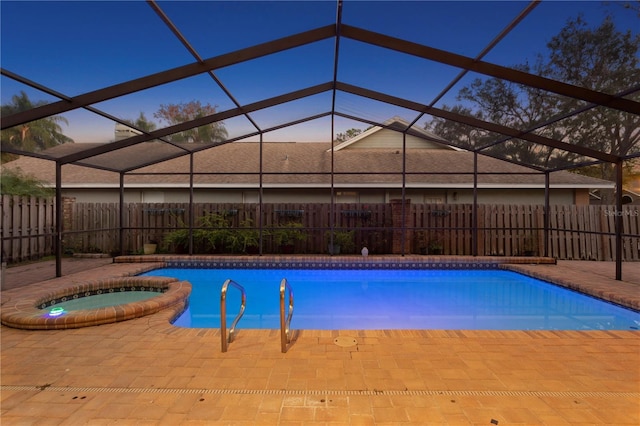8701 Ballantrae Way, Tampa, FL 33647 - pool at dusk with an in ground hot tub, a lanai, and a patio