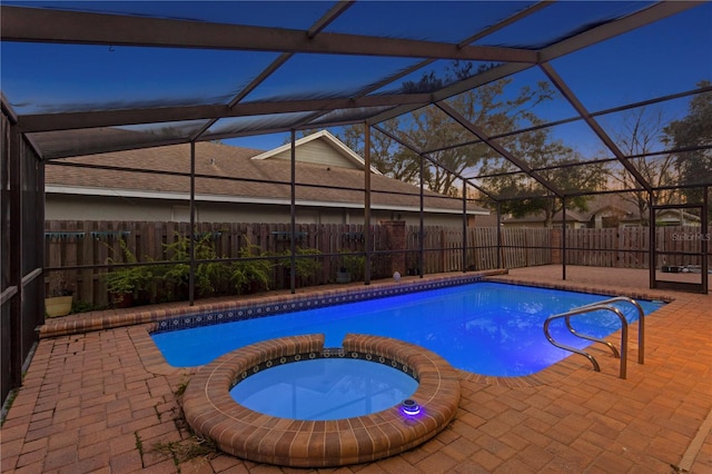 8701 Ballantrae Way, Tampa, FL 33647 - pool at dusk featuring a lanai, a patio area, and an in ground hot tub