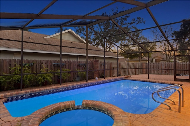 8701 Ballantrae Way, Tampa, FL 33647 - pool at dusk featuring a patio and a lanai