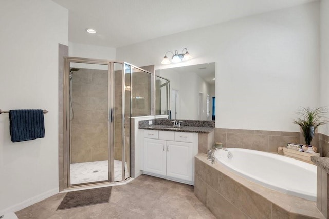 full bathroom featuring vanity, a garden tub, and a shower stall